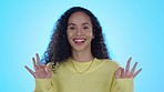 Okay sign, excited and face of woman in studio for approve, agreement or perfect on blue background. Yes emoji, happy and portrait of female person with hand gesture for success, support or thank you