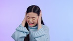 Face, woman and covering ears or shouting for anxiety, fear or mental health on purple background. Portrait of frustrated or scared asian person shaking head for noise, rage or depression and stress 