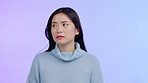 Asian woman, thinking and anxiety on face with worried, fear and anxious feeling isolated in a purple studio background. Upset, anxiety or sad model and person with depression, crisis or trauma 