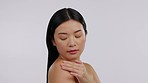 Asian woman, skincare and beauty, touching skin with glow, cosmetic care and soft on studio background. Dermatology, treatment and female model, hygiene and natural cosmetics with mockup space