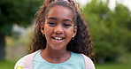 Face, child or girl laughing outdoor in a garden, park or green environment for fun and happiness. Portrait of a young African female kid with a positive mindset, cute smile and nature to relax