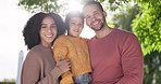 Love, portrait of a happy family and smile with a lens flare on the lawn of their home together. Support or care, happiness or positivity and people smile in the backyard for quality time outside