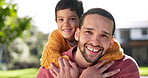 Father, happiness and son on back in outdoor with bonding for relationship with sunshine or fun. Smile, boy and hugging dad from behind in garden with playing in nature at house for quality time.