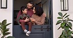 Love, talking and parents with their child by the door of their family house for fresh air. Happy, smile and young couple speaking, holding and bonding with boy kid by their modern home together.