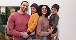 Love, happy and face of parents with their children while playing together in the outdoor garden. Happiness, smile and young couple holding, having fun and bonding with boy kids by their family home.