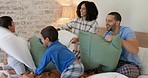 Happy family, pillow fight and bedroom with kids, playing and excited with love, bonding and care in home. Man, woman and boy children on bed for game, playful conflict or comic quality time in house