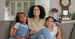 Love, happy and mother with her children on a sofa watching a movie in the living room of their house. Bonding, happiness and young mom holding her girl kids while streaming a show together at home.