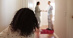 Back, parents fighting and girl in the hallway of her house, watching an argument, conflict or dispute. Kids, divorce or breakup with a young female child looking at her mother and father disagree