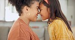 Love, happy and mother with affection to her child while bonding in the living room of their home. Happiness, smile and young mom in sweet moment with her girl kid in the lounge of their family house