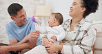 Couple, family and quality time with baby, mom and dad playing with toys for fun, laughing together in home, bedroom or nursery. Newborn, infant and happiness in motherhood, family or child smile