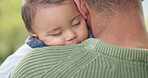 Family, park and baby sleeping on his father outdoor during summer while bonding together for love. Kids, care and dreaming with an infant child lying on the shoulder of a parent in the backyard