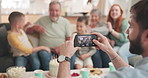 Phone, screen and photographer for family together in home with grandparents, children and mom in a picture or memory. Group, mobile and focus on lens, app or capture portrait of people on smartphone