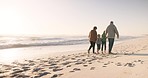 Holding hands, grandparents and grandkids walking on the beach, family and nature with back view and ocean. Love, care and support, vacation and solidarity, old woman and man with children outdoor