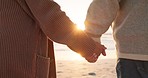 Love, beach and senior couple holding hands by ocean for commitment, bonding and quality time at sunset. Marriage, travel and man and woman embrace for romance on holiday, vacation and anniversary