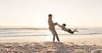 Summer, beach and a man swinging his son outdoor by the ocean while playing or bonding on vacation. Family, children and a young father having fun with his kid on the coast at sunset together