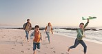 Happy, holiday and family running, seaside vacation or energy with happiness, ocean or loving together. Parents, mother or father with children, adventure or relax with stress relief or beach getaway