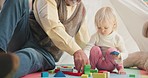 Building blocks, playful and senior man with his grandchild in her playroom or nursery in their house. Happy, smile and grandfather talking and playing with a girl kid with her toys in their home.