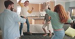 Dance, happy and family having fun in the living room together with music, playlist or the radio. Jumping, happiness and children dancing on the sofa with their parents to a song for bonding at home.