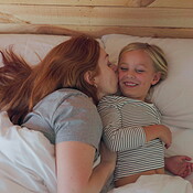 Bed, wake up and a mother kissing her daughter in the morning after sleeping in their home together. Smile, relax or early with a woman and girl child lying in a bedroom for bonding over the weekend | Buy Stock Photo on PeopleImages, Picture And Royalty Free Image. Pic 2832122 - PeopleImages