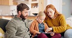 Digital tablet, relax and parents with their child on a sofa in the living room of their house. Technology, bonding and girl kid playing an online game with her young mother and father in family home