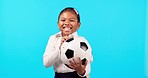 Girl child, football and studio for smile on face, dancing or backpack for sport, learning or excited by blue background. Young female kid, school uniform and soccer ball with comic laugh in portrait