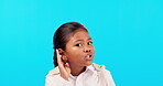 Finger on lips, silent and secret with a girl on a blue background in studio for gossip or news. Portrait, whisper and quiet with a cute or sneaky girl child posing to hear private information