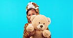 Happy, face and a child with a teddy bear on a blue background for playing, fun and childhood. Smile, playful and portrait of a little young girl with a toy isolated on a studio backdrop with mockup