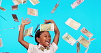 Happy little girl, money rain and celebration for savings in financial freedom against a blue studio background. Female child or kid with smile for winning cash, loan or finance investment or lottery