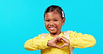 Portrait, girl with heart hand sign and against blue background with smile. Happy or support, mockup space or thank you and female child with hands for love emoji or romantic gesture in backdrop