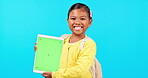 Happy little girl, tablet and mockup for social media advertising against a blue studio background. Portrait of female child smile with technology in online communication, advertisement or networking