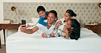 Phone, selfie and family together on bed for happy portrait, memory and social media post of bonding, quality time or weekend. Morning with dad, mom and children in bedroom waking up and relaxing