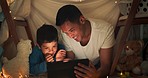 Night, father and boy on tablet in tent watching movies, online games and cartoon by blanket. Family, happy and dad with son and fairy lights in bedroom on digital tech for bonding, relax and love