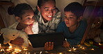 Comedy, tablet and mother streaming children in a tent house laughing at internet video, show or movie online at night. Dark, digital and parent relax with kids watching funny app in the evening