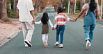 Back, family and holding hands in the street, walking and healthy with quality time, wellness and bonding. Parents, mother and father with children, road and travel with support, commute and hobby