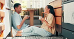 Talking, coffee and a happy couple at home with love, care and communication. Young woman and man laughing while drinking tea together to bond for happiness, quality time and conversation on a floor