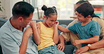 Tickle, family and children with parents in a living room at home for comfort. Young kids, happy man and woman or mom and dad for fun, happiness and love while playing, laughing and bonding on a sofa