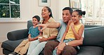 Happy, TV and excited family on sofa with popcorn for bonding, quality time and relaxing in living room. Home, parents and mother, father and children on couch streaming comedy movies on television