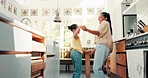 Kitchen, happy and mother dancing with her child for bonding, having fun and spending time together. Happiness, goofy and young mom singing and doing a dance to music with her girl kid at family home