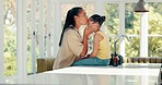 Kiss, mother and child ready for school on a kitchen table with a backpack and smile. Morning, girl kid and woman together at home to prepare for education or learning with love and care of a mom