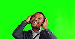Music, happy and business with black man on green screen for streaming, audio and media. Headphones, corporate and technology with person listening on studio background for  podcast, sound and mockup