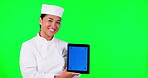 Tablet, cooking and a woman chef on green screen background in studio holding a display with tracking markers. Portrait, food website and a happy young asian female cook holding chromakey mockup