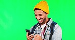 Young man, phone and celebration by green screen for success, goal or results in studio mock up. Young Asian guy, student and smartphone for fintech, gambling or bonus with investing in crypto on web
