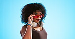 Face, sunglasses and beauty of woman in studio isolated on a blue background. Fashion portrait, smile shades and happy female model with trendy, stylish or retro, cool or gen z headphones.