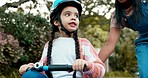 Bike, mother and daughter with learning, street and outdoor in neighborhood with smile, support and play. Woman, girl child and bicycle with teaching, happy and street for speed, training and helmet