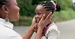 Black mother, kiss and girl with care at park for quality time with happiness with kid for love. Forest, affection and mom and daughter in forest with smile for bonding in childhood with parent.