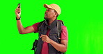 Hiking, man and phone with problem on green screen and angry or frustrated with network service, connection or contact. Person with a backpack, smartphone and studio background for internet or signal