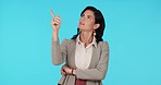 Corporate thinking, pointing or studio woman gesture at sales product review, retail planning or comparison mockup. Portrait, decision or business person question commercial choice on blue background