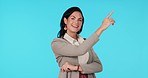 Face of woman, presentation and pointing to list of business information, opportunity or blue background in studio. Happy portrait, female worker or advertising mockup space of menu, process or steps