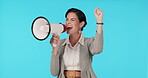 Megaphone, protest and motivation with a woman screaming in studio on a blue background for support at a rally. Noise, announcement and information with a young female speaker shouting propaganda