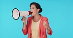 Studio, shouting or woman with megaphone for speech, protest or activism for human rights or equality. Blue background, loudspeaker broadcast or angry person with voice or mic for change or justice